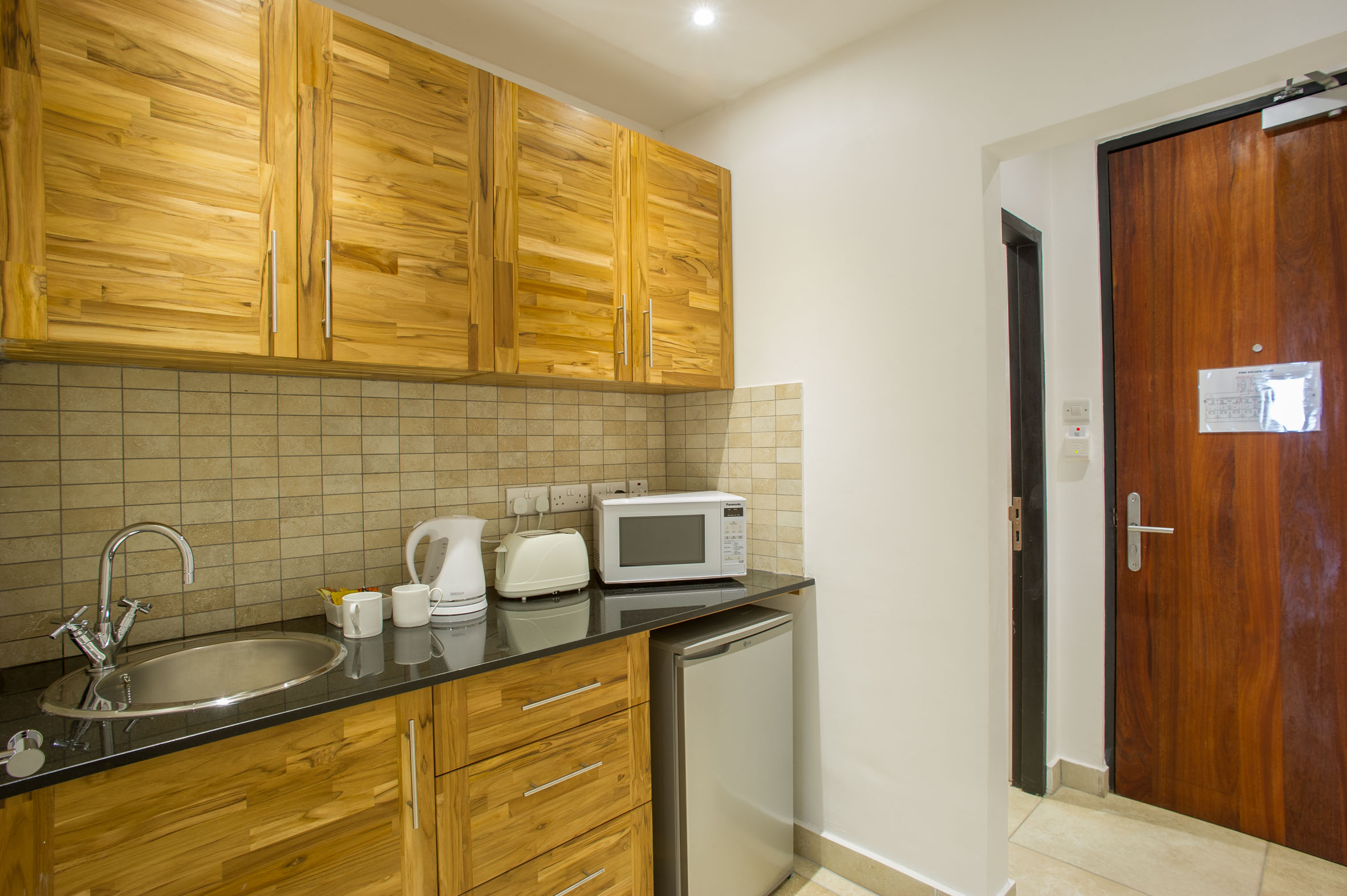 Galley-style Kitchen in Suite at The Oyster Bay Hotel Suites